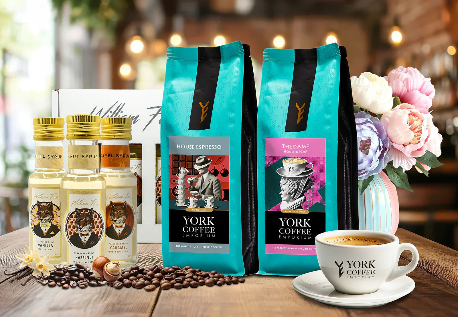 York Coffee Emporium gift set with House Espresso, The Dame Decaf, William Fox syrups, and a branded coffee cup on a table.