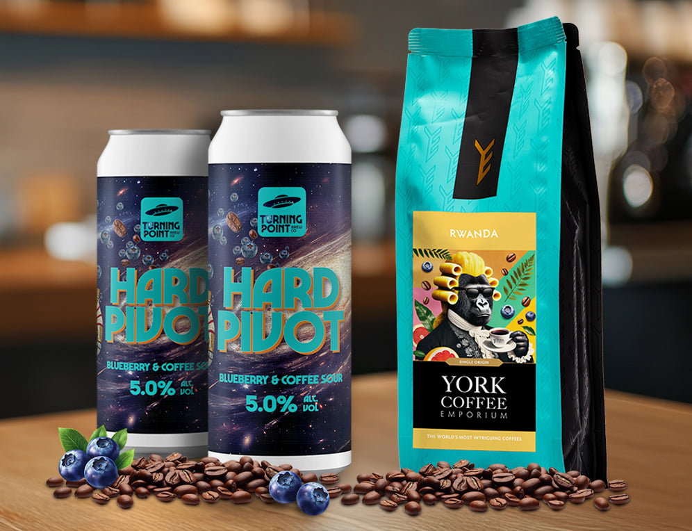 Two cans of Turning Point’s Hard Pivot blueberry and coffee sour next to a bag of York Coffee Emporium’s Rwanda coffee with illustrated gorilla label.