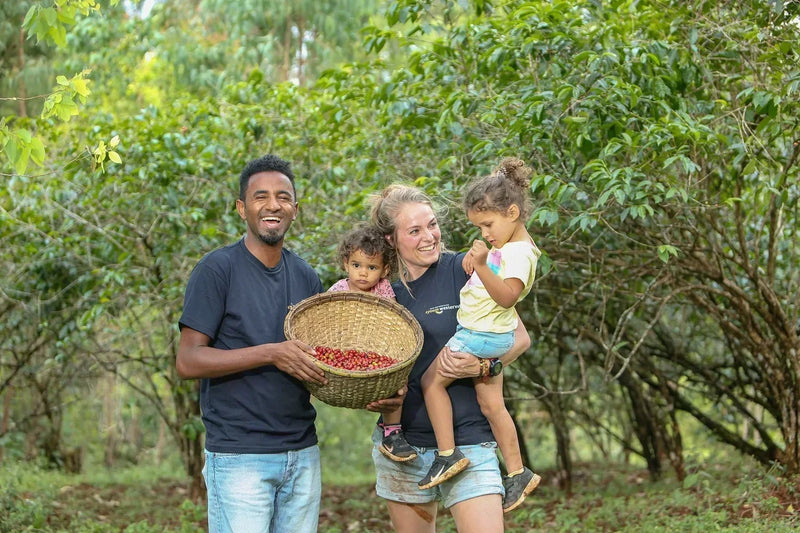 Dawit and Hester Syoum of Bette Buna with their children and a basket of coffee cherry in Ethiopia