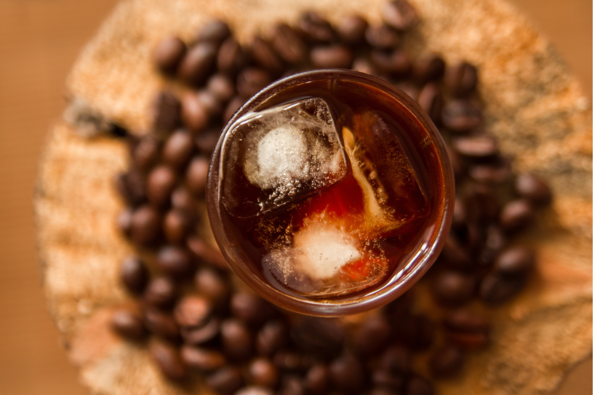 Ice coffee on dark coffee bean background