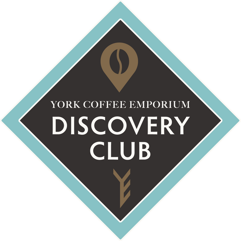York Coffee Emporium Discovery Club logo featuring a diamond-shaped badge with a coffee bean marker icon and stylised YCE initials.